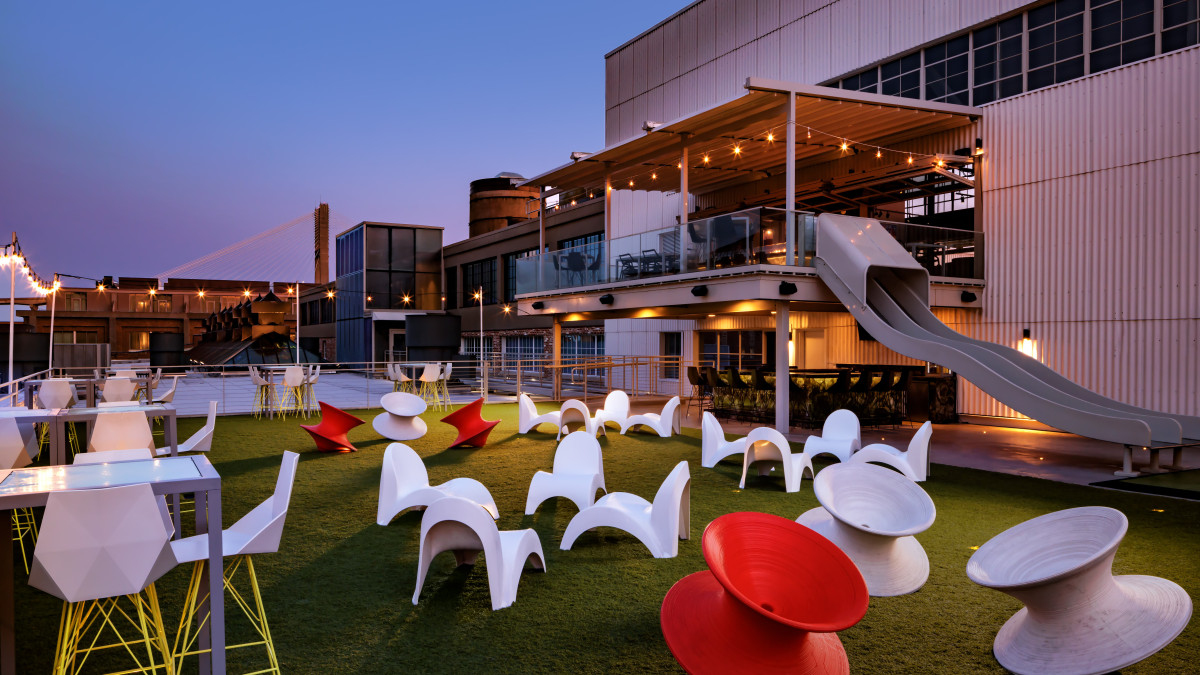 A rooftop bar with eclectic and modernized seating overlooking the Savannah River.