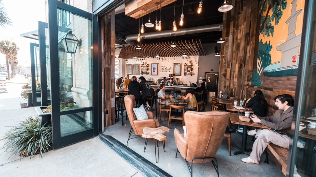 A riverside coffee shop with opened double doors.