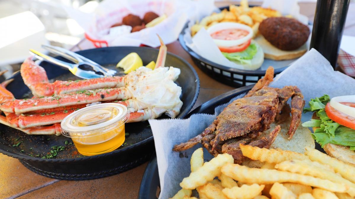 Numerous seafood dishes on an outdoor table.