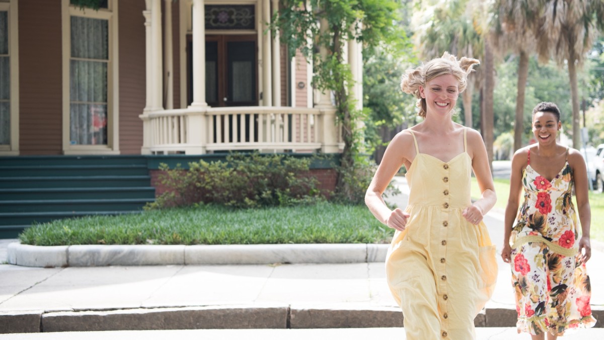 Two friends running through Savannah’s Victorian District neighborhood.