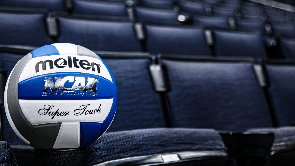 A blue and white volleyball positioned on a stadium seat.