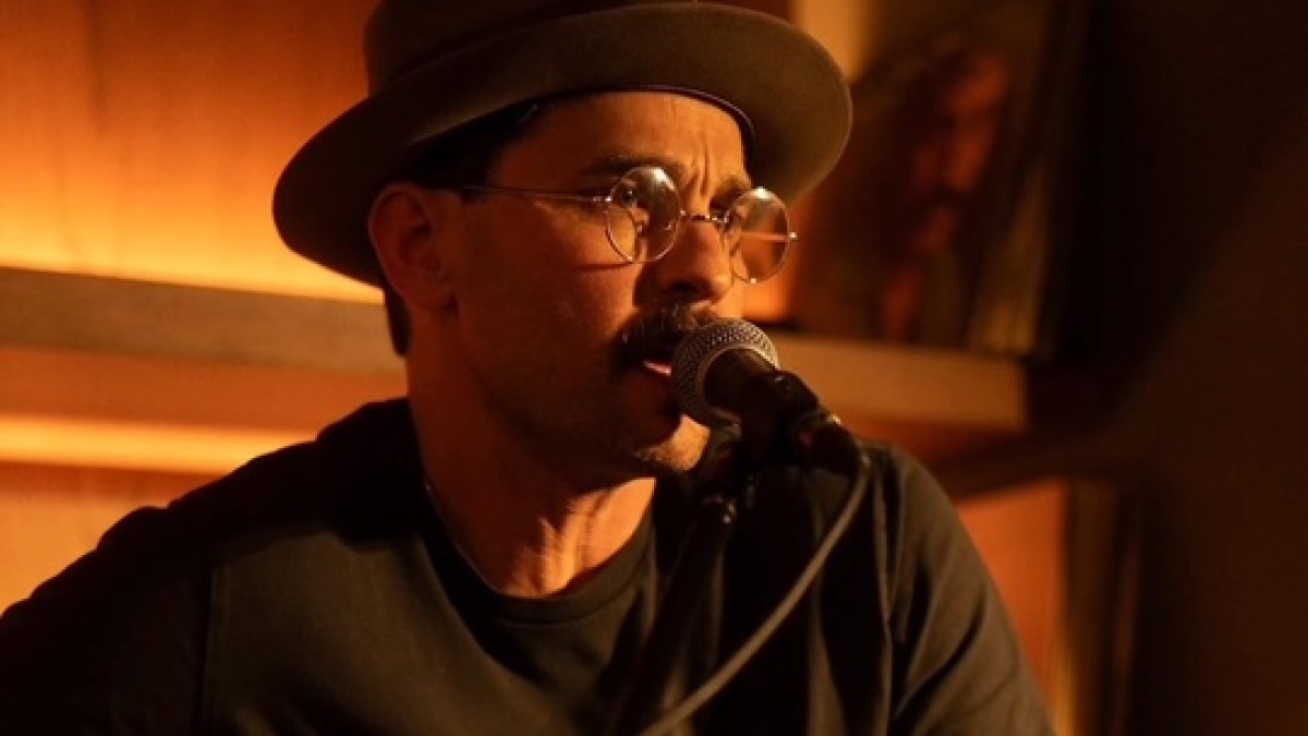 A singer performing with an acoustic guitar.