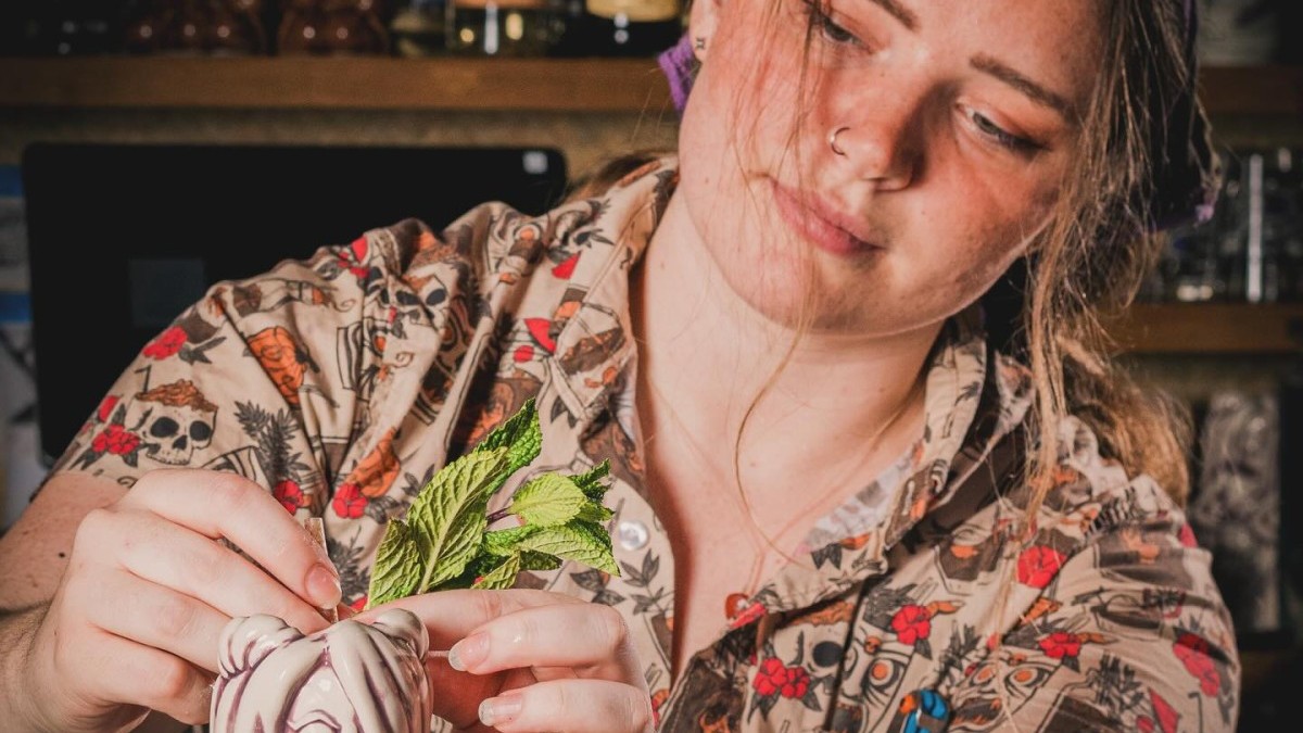 A bartender preparing a cocktail.