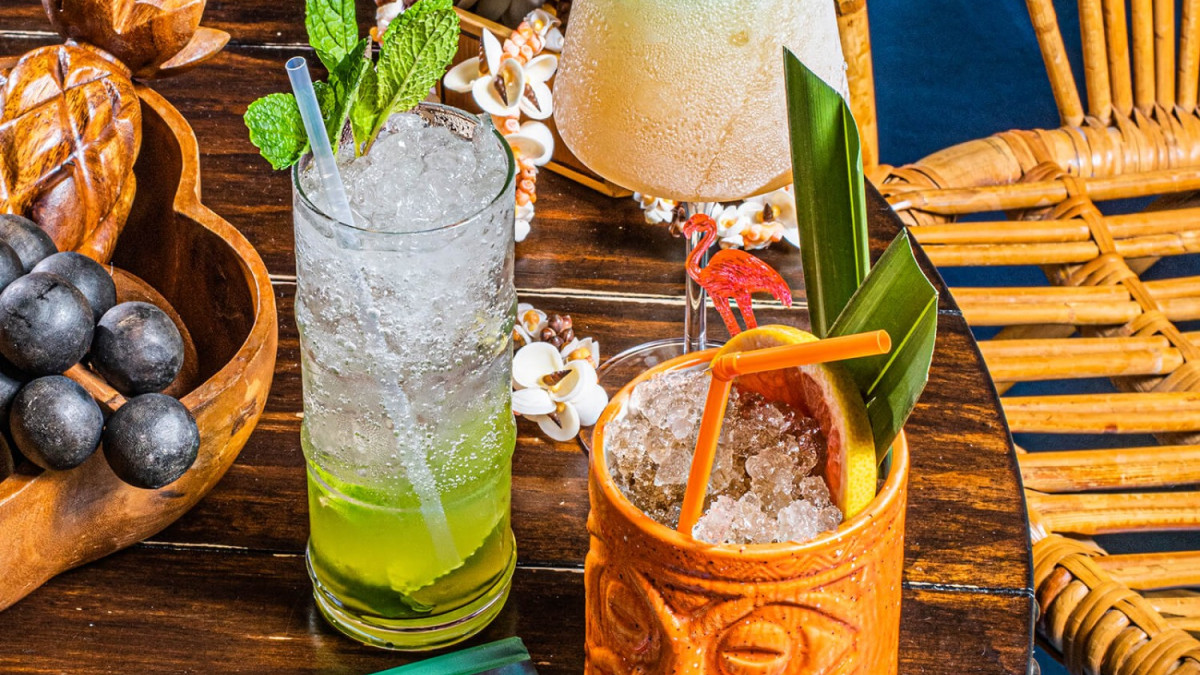 Multiple tropical-themed cocktails on a table.
