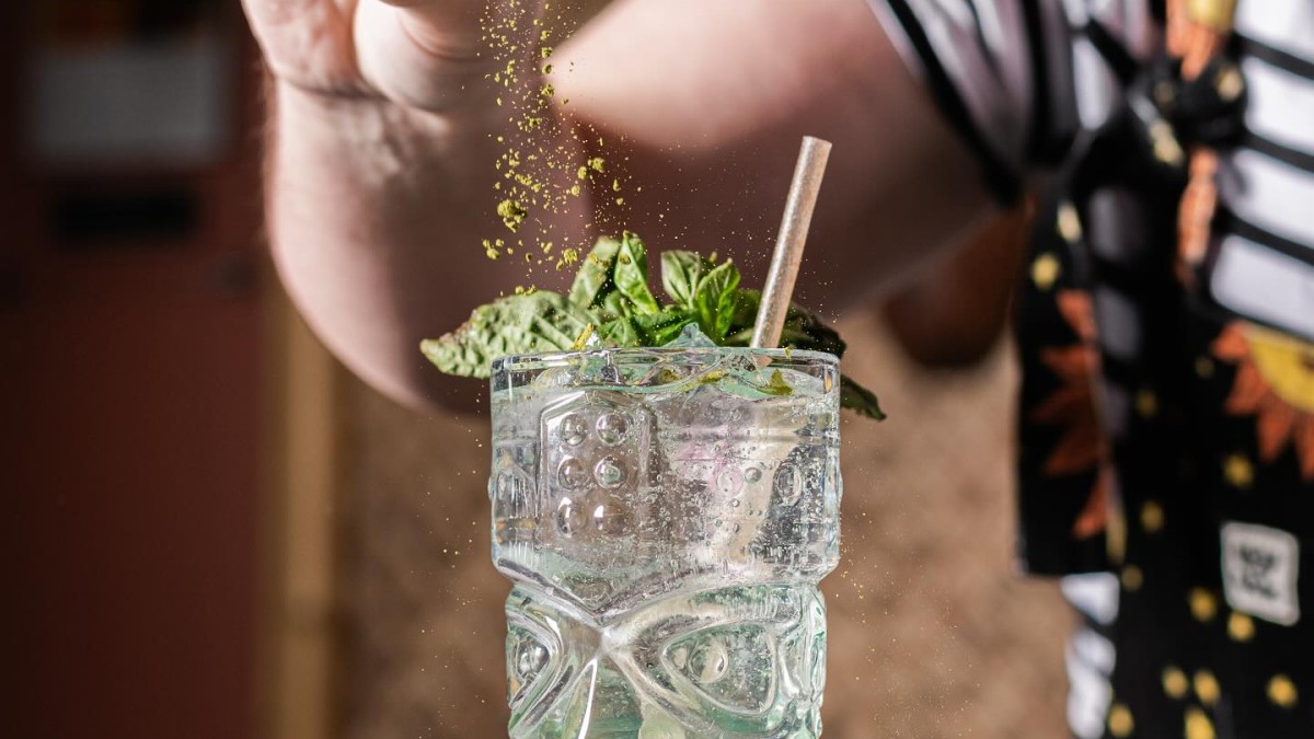 A bartender creating a tiki-inspired cocktail.