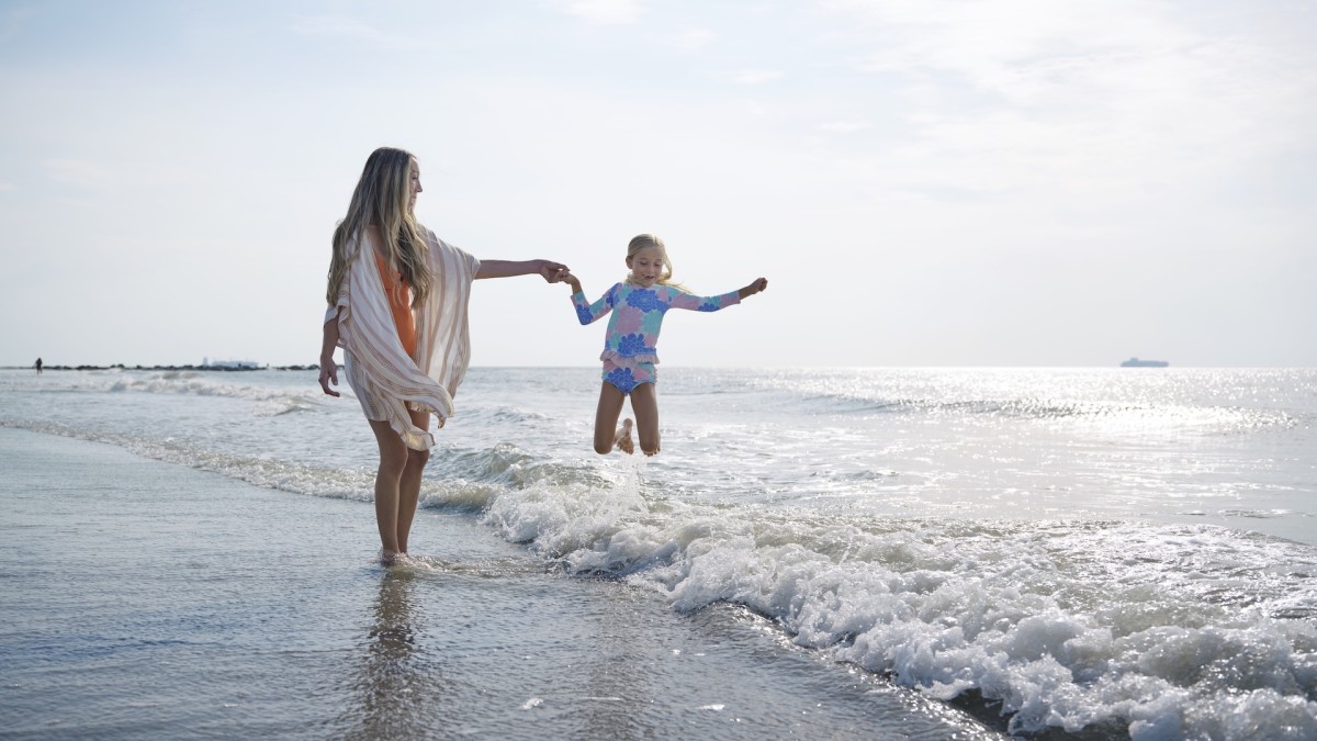 Mom and daughter playing in the ocean on Tybee Island, GA.