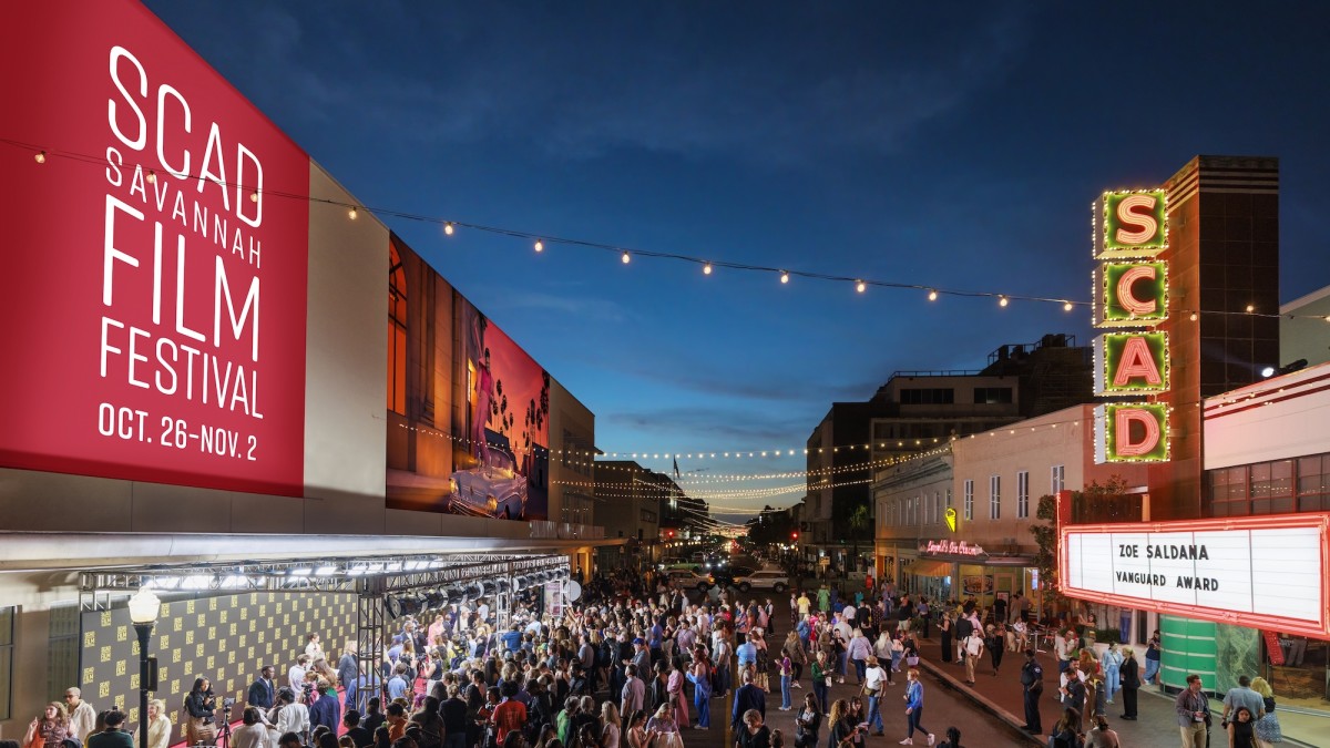A large crowd gathered outside of a theatre for a film festival.
