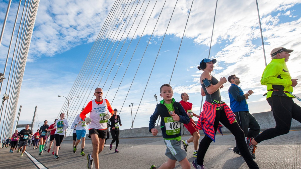 children, men and women running on a bridge in a race