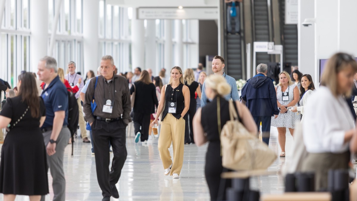 Groups of people walking throughout the Savannah Convention Center.