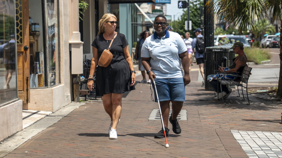 Blind walker and companion on Broughton Street
