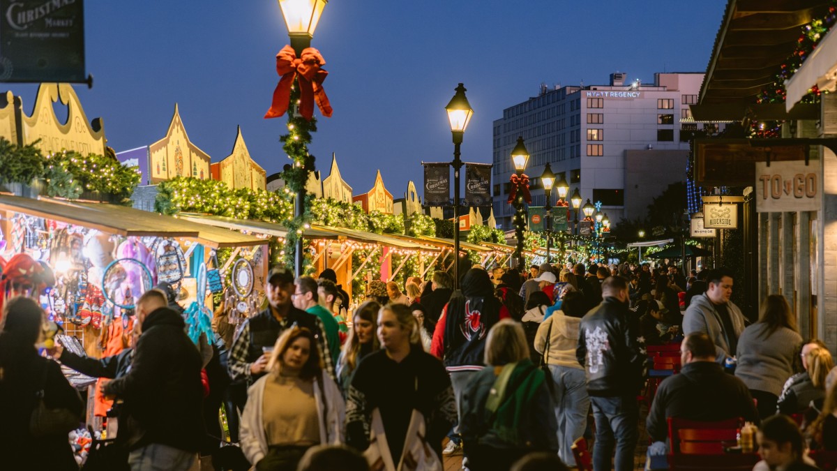 An outdoor Christmas Market with vendors along the Savannah River.