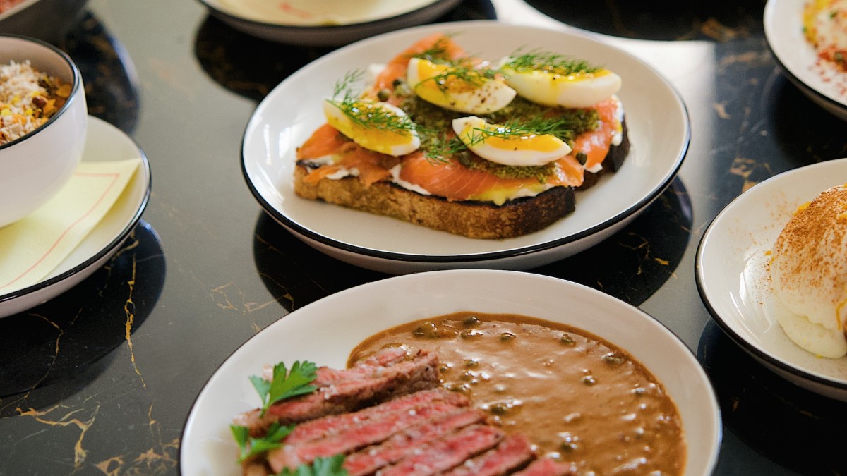 Brunch spread with steak, salmon toast and berry parfait.