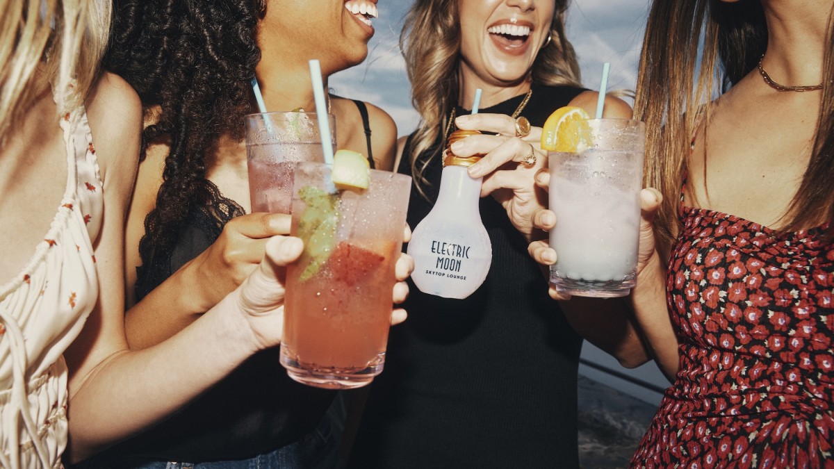 A group of girlfriends enjoying cocktails at Electirc Moon Skytop Lounge.
