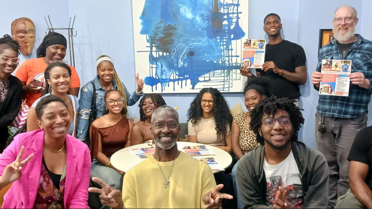 A large group posing during a tea class with the owner of Ashford Tea Company.