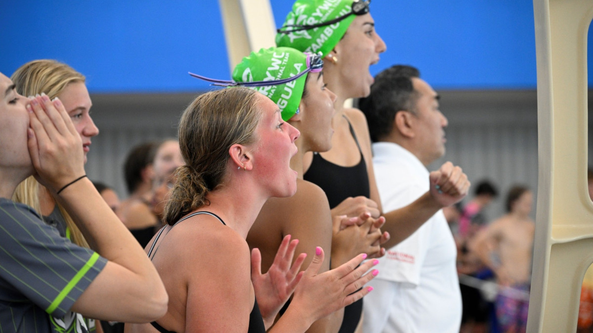 A group of teens cheering each other on at a swim meet at the West Broad Street YMCA in Savannah, GA.