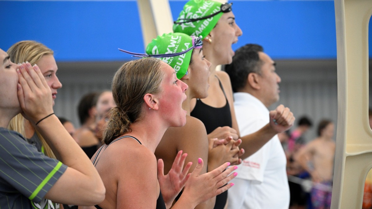 A group of teens cheering each other on at a swim meet at the West Broad Street YMCA in Savannah, GA.