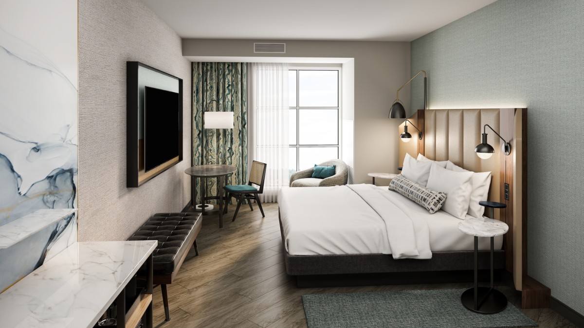 Guest room at Tempo by Hilton Savannah Historic District with a modern bed, seating area and large window.