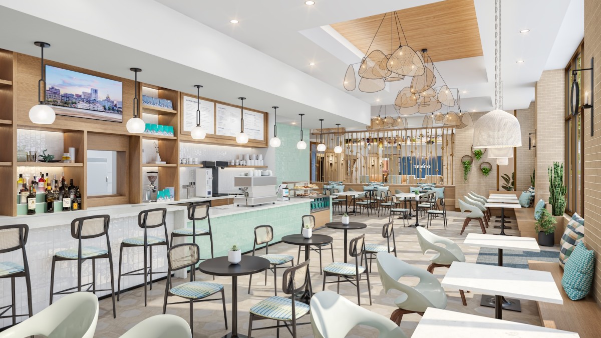 Interior of Bluestone Lane café at Tempo by Hilton Savannah Historic District, featuring a bright, modern coffee bar with light wood accents, pendant lighting, café seating and an open, airy dining space.