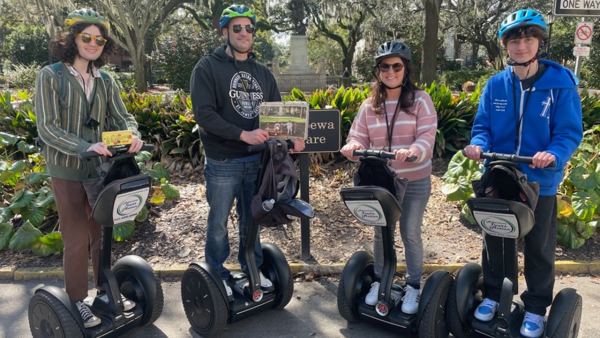 A group posing for a photo on segways with Adventure Tours in Motion