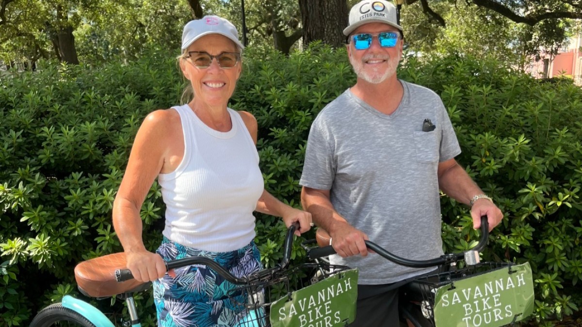 A couple posing for a photo on bikes with Savannah Bike Tours.