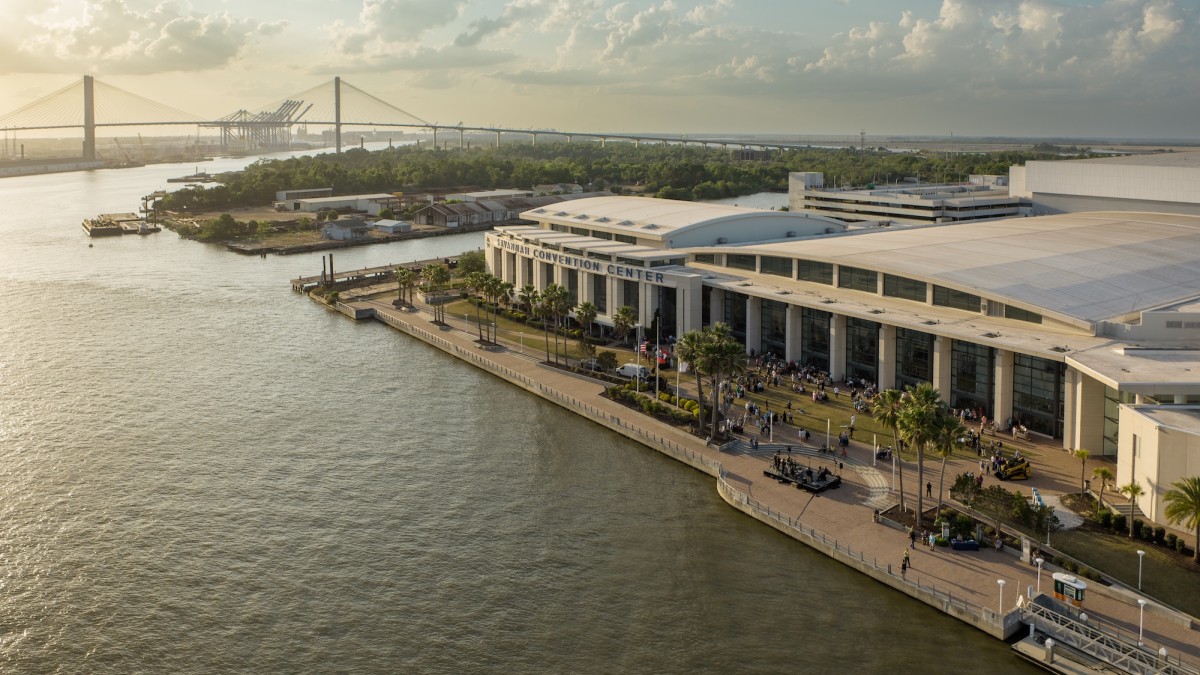 Savannah Convention Center along the Savannah River with waterfront promenade and Talmadge Memorial Bridge in the background.