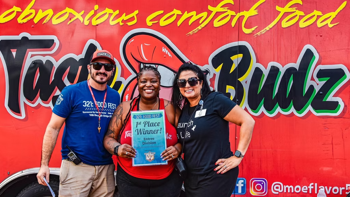 People posing with award in front of Taste of Bubz food truck at Savannah Food Fest in Savannah, GA.