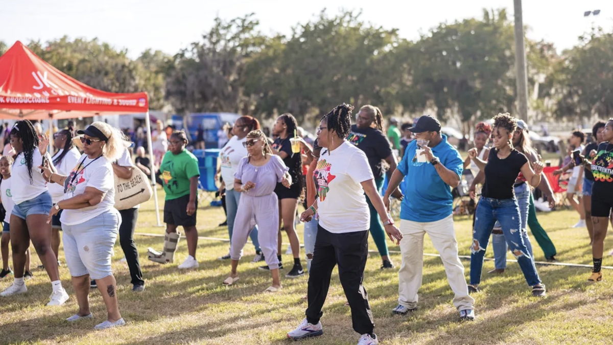 Attendees dancing and celebrating at the Savannah Juneteenth Festival.
