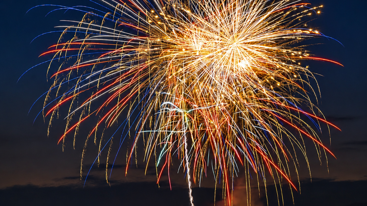 Fireworks burst over the water during a Fourth of July celebration.
