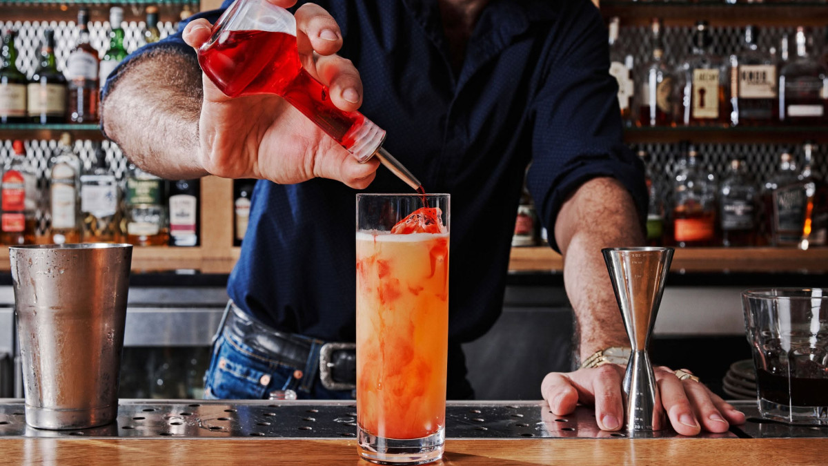 A bartender prepares a cocktail.