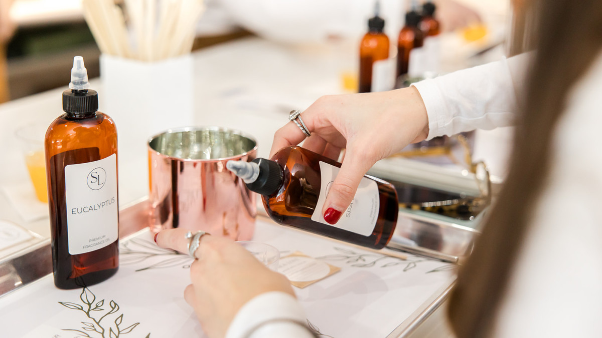 A person mixing scents to create a candle.