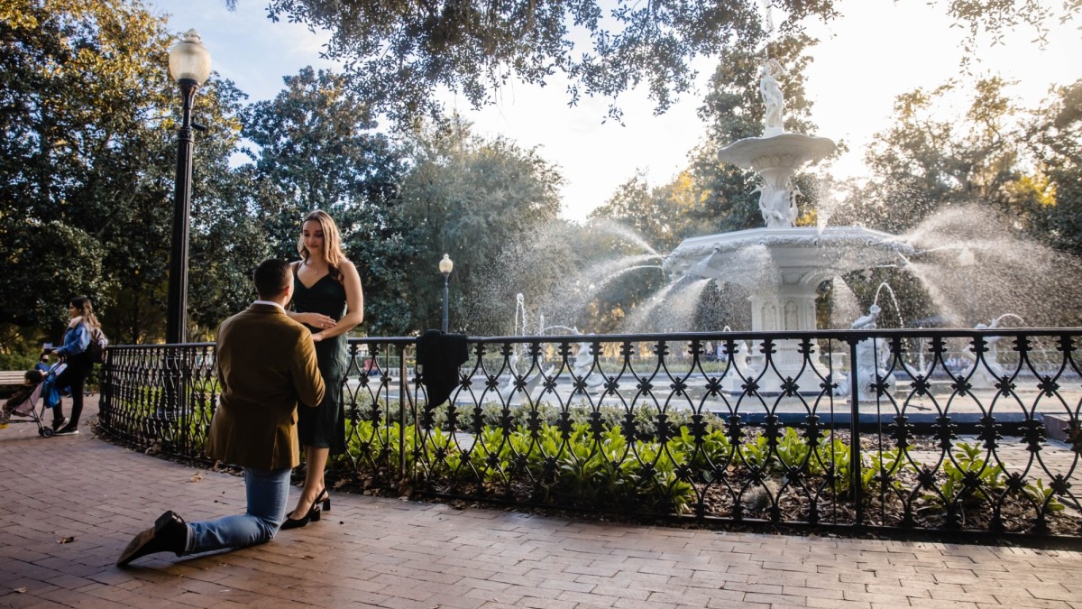 A couple gets engaged in Forsyth Park in Savannah, Georgia