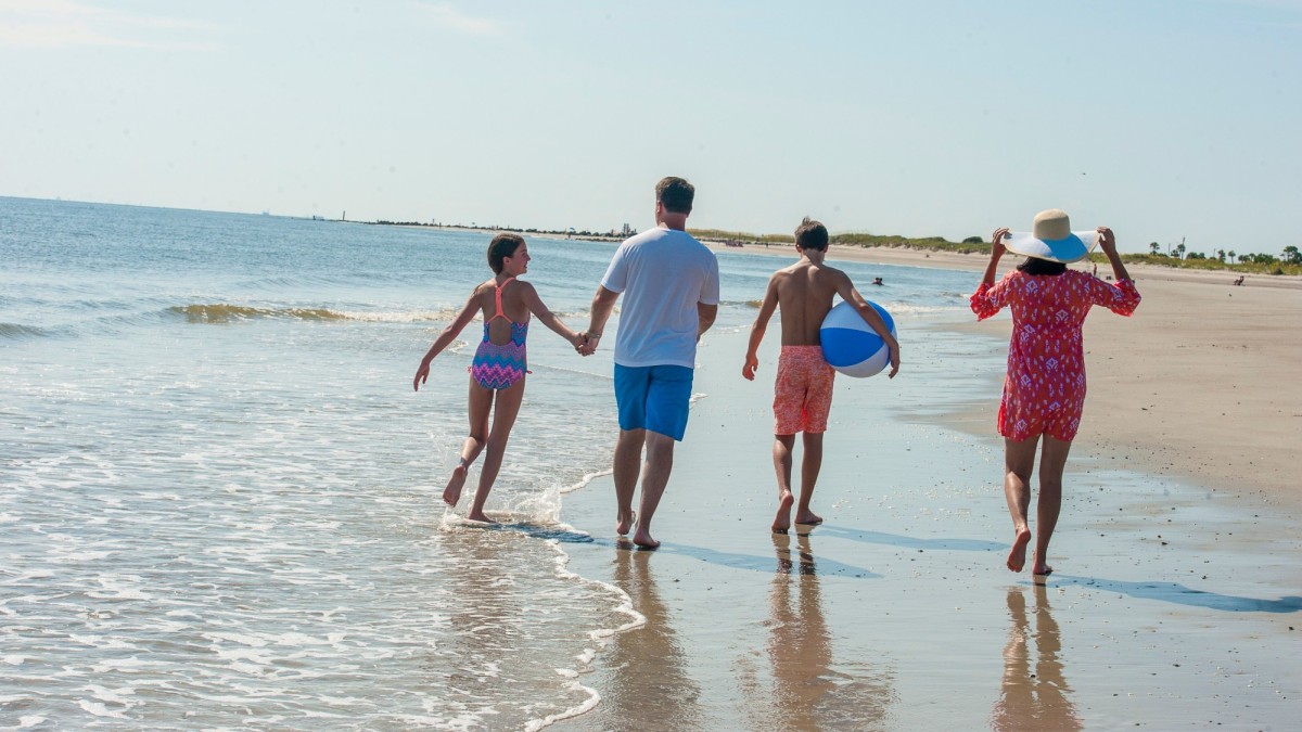 A family of four at the beach on Tybee Island, Georgia.