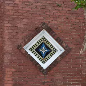 brick exterior with diamond shaped window