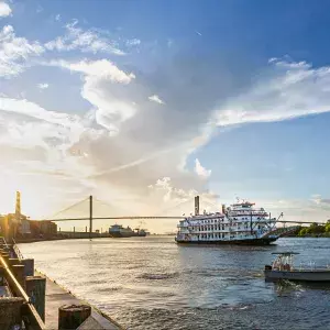 River Street at sunset with a riverboat on the water