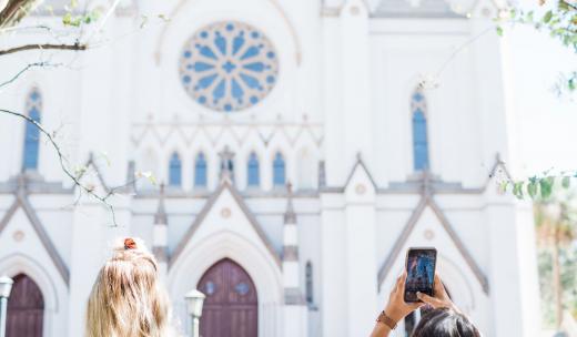 The Cathedral of St. John the Baptist is an iconic architectural masterpiece. Visitors snap photos of the Cathedral of St. John the Baptist