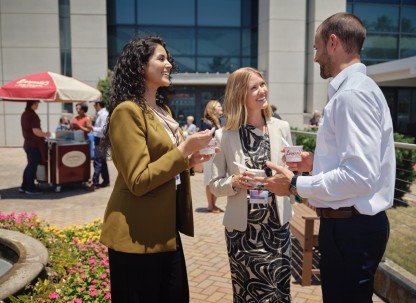 attendees outside convention center talking and eating ice cream