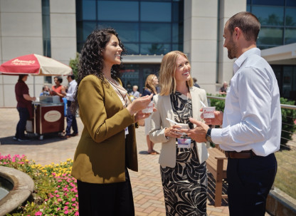attendees outside convention center talking and eating ice cream
