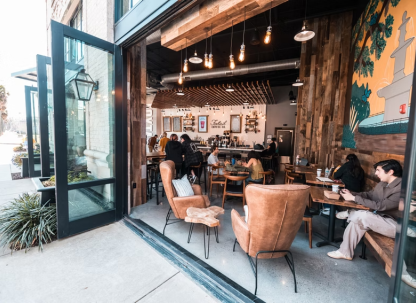 A riverside coffee shop with opened double doors.