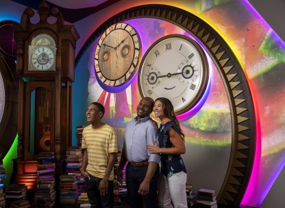 A family of three enjoying an immersive 4D story experience about the history of Savannah College of Art and Design.