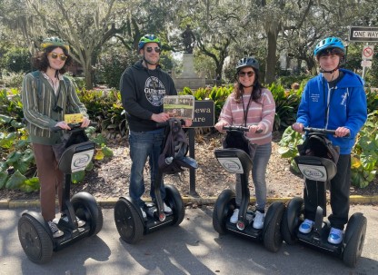 A group posing for a photo on segways with Adventure Tours in Motion