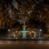 An eerie view of Forsyth Park at night