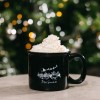 holiday Coquito cocktail with whipped cream in front of a christmas tree