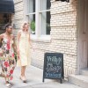 Two friends walking towards a vintage shop.