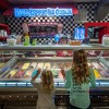 Kids looking at ice cream at River Street Sweets in Savannah, Georgia.