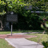 A man looks at The Weeping Time Historic Marker in Savannah, Georgia