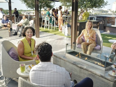 group chatting on rooftop overlooking river