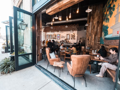 A riverside coffee shop with opened double doors.