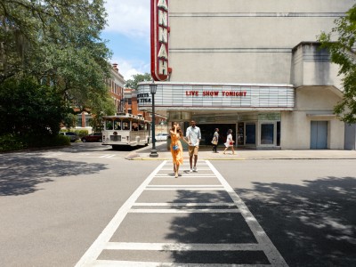 A young couple walking away from the Savannah Theatre in Savannah, GA.