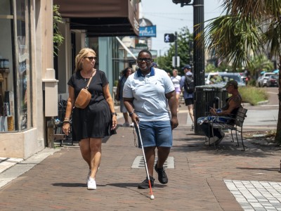 Blind walker and companion on Broughton Street