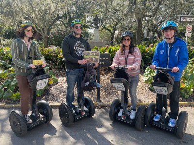 A group posing for a photo on segways with Adventure Tours in Motion